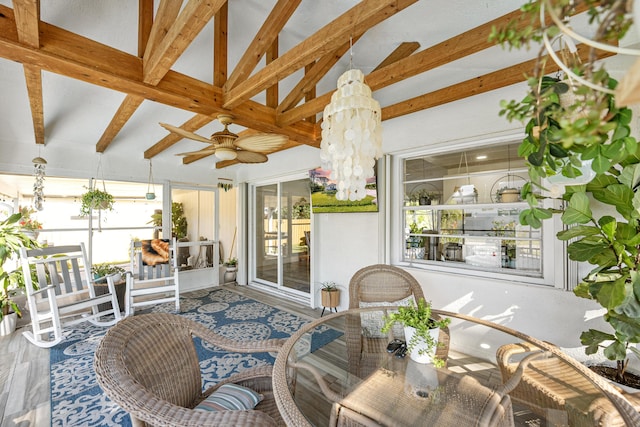 sunroom / solarium featuring a notable chandelier and vaulted ceiling with beams