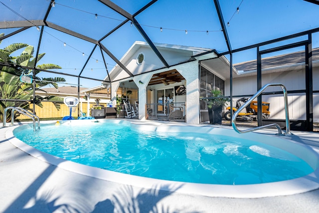 view of swimming pool featuring a lanai, a patio area, a fenced in pool, and ceiling fan