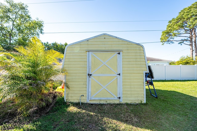 view of shed featuring fence