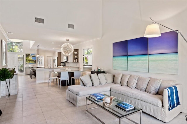 living room featuring crown molding, light tile patterned floors, visible vents, and a towering ceiling