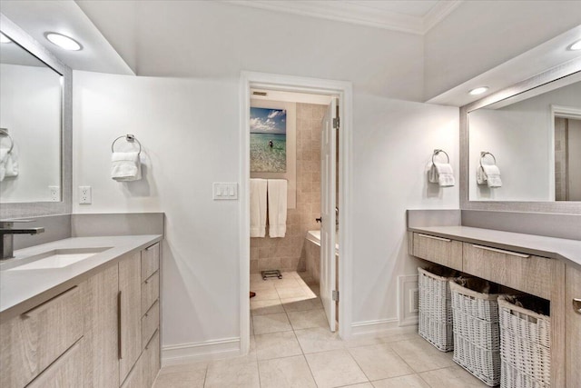 bathroom with tiled bath, baseboards, ornamental molding, tile patterned floors, and vanity