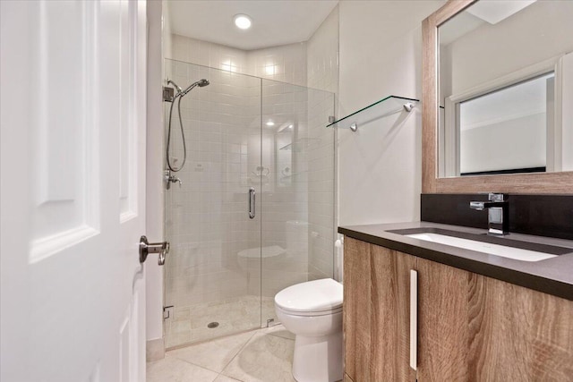 full bathroom with tile patterned floors, a stall shower, toilet, and vanity