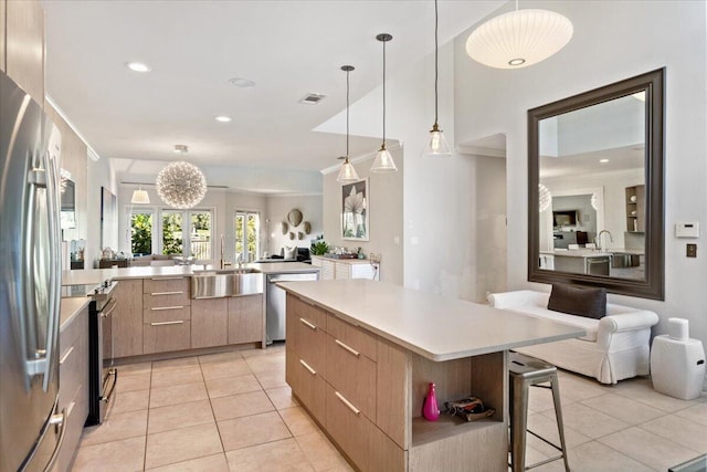 kitchen with visible vents, open floor plan, light tile patterned floors, stainless steel appliances, and modern cabinets