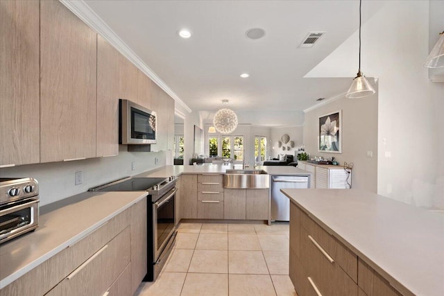 kitchen with crown molding, light brown cabinets, open floor plan, and appliances with stainless steel finishes