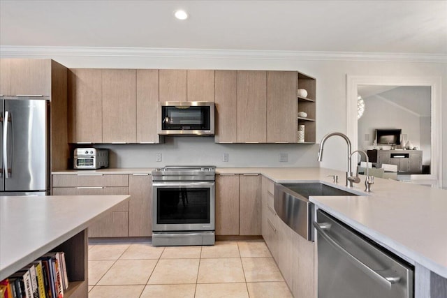 kitchen featuring open shelves, crown molding, light countertops, stainless steel appliances, and a sink