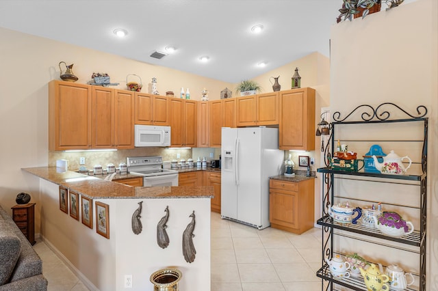 kitchen with visible vents, stone countertops, white appliances, a peninsula, and light tile patterned flooring