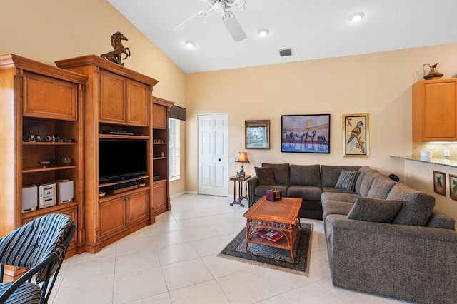 living area with light tile patterned floors, visible vents, high vaulted ceiling, and ceiling fan