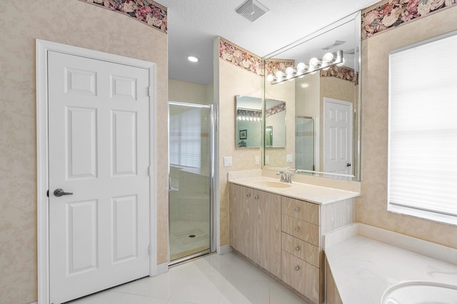 bathroom with a stall shower, vanity, and wallpapered walls