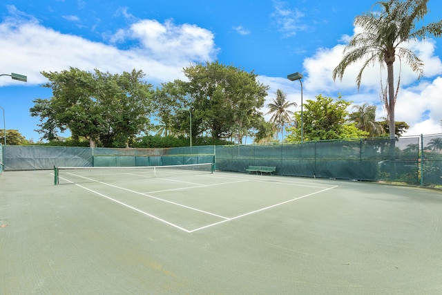 view of sport court featuring fence