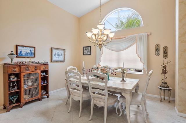 dining space featuring baseboards, high vaulted ceiling, a chandelier, and light tile patterned flooring