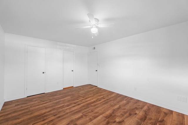 unfurnished bedroom with visible vents, ceiling fan, and wood finished floors