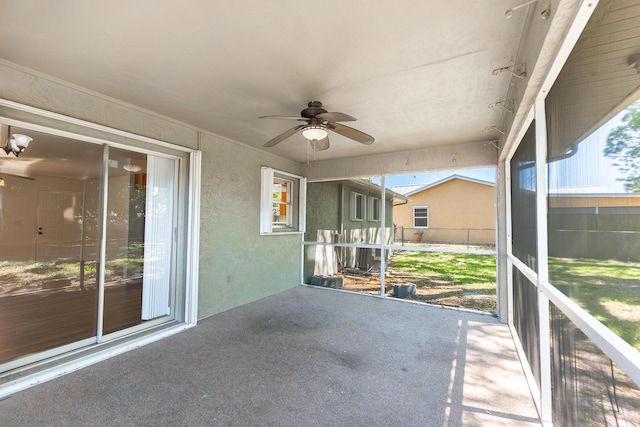 unfurnished sunroom with a ceiling fan