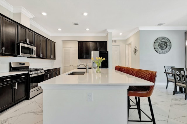 kitchen featuring visible vents, marble finish floor, a sink, appliances with stainless steel finishes, and a breakfast bar area