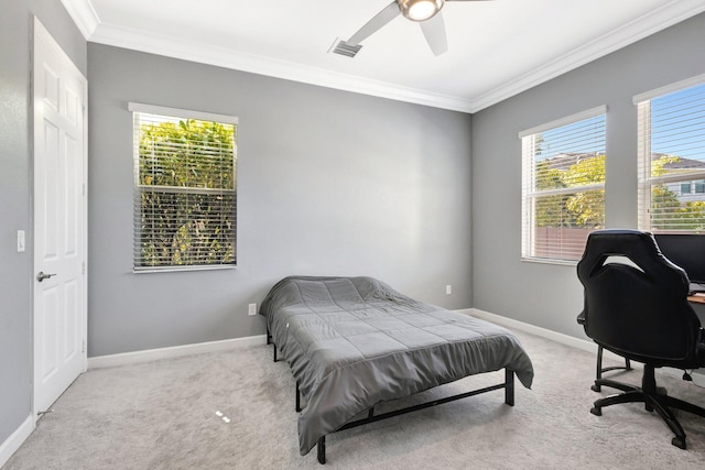 bedroom with visible vents, crown molding, baseboards, ceiling fan, and carpet flooring