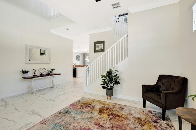 foyer with visible vents, marble finish floor, crown molding, baseboards, and stairs