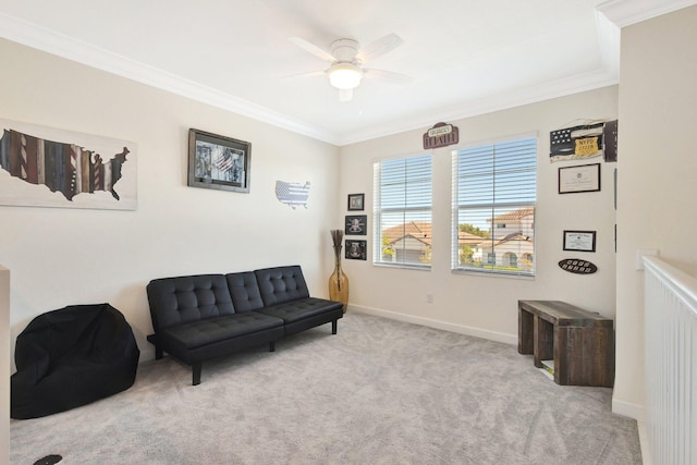 sitting room featuring ceiling fan, baseboards, carpet, and ornamental molding