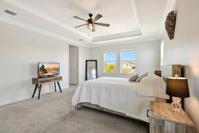 bedroom featuring visible vents, crown molding, a raised ceiling, and carpet floors