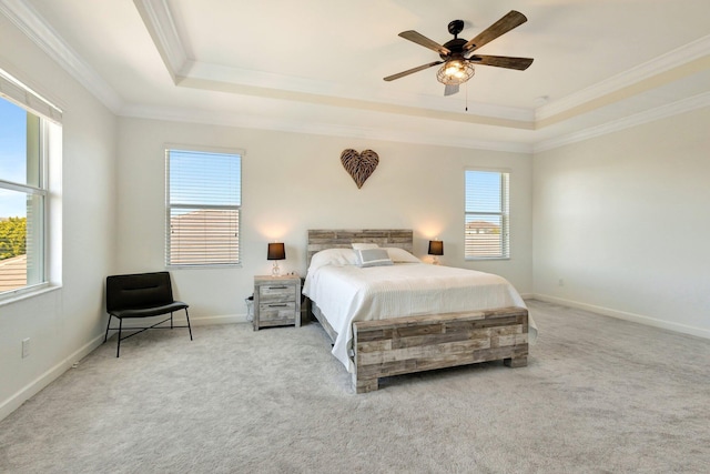 bedroom featuring baseboards, a raised ceiling, carpet flooring, and crown molding