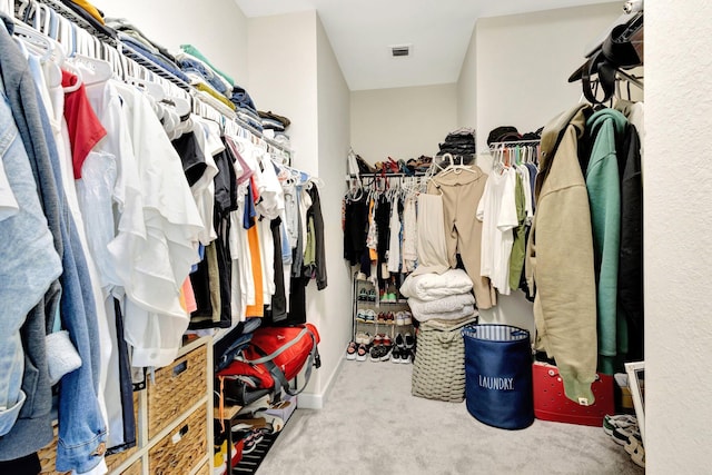 walk in closet featuring carpet flooring and visible vents