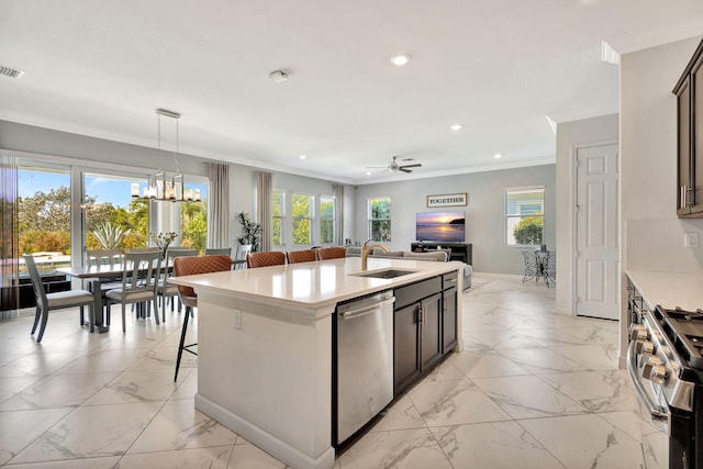 kitchen with a sink, appliances with stainless steel finishes, ornamental molding, and light countertops