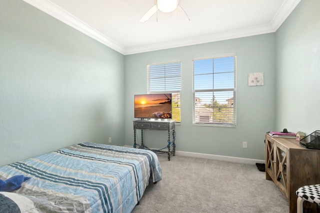 carpeted bedroom with crown molding, a ceiling fan, and baseboards