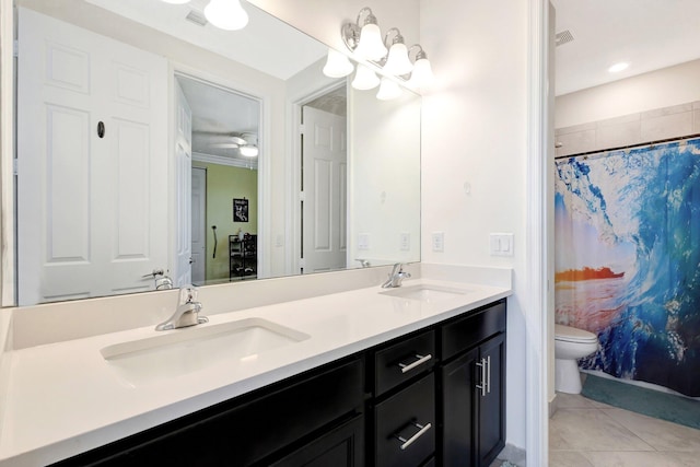 full bath with double vanity, tile patterned floors, toilet, and a sink