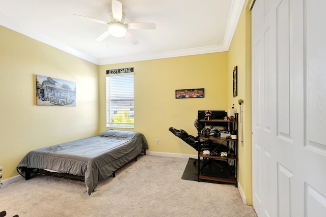 bedroom with baseboards, ornamental molding, light carpet, a closet, and a ceiling fan