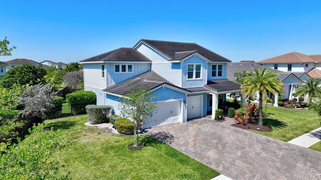 1009 Sterling Pine Pl, Loxahatchee, FL 33470 - traditional home featuring decorative driveway, a front lawn, and a garage