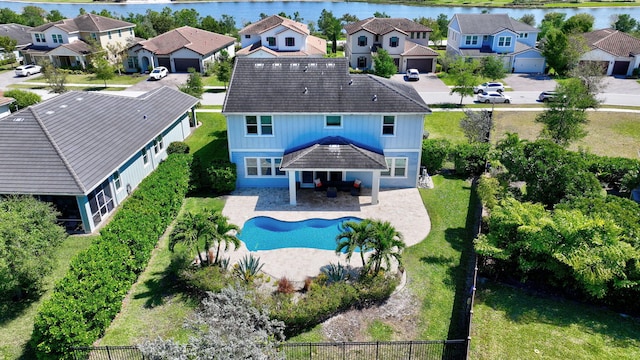 exterior space with a patio area, a residential view, fence private yard, and a water view