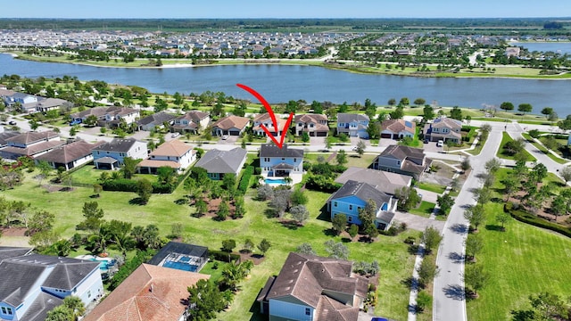 bird's eye view featuring a residential view and a water view