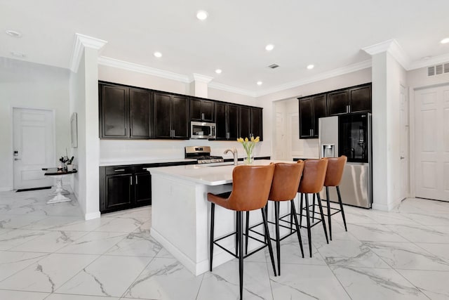 kitchen with visible vents, marble finish floor, appliances with stainless steel finishes, and a breakfast bar