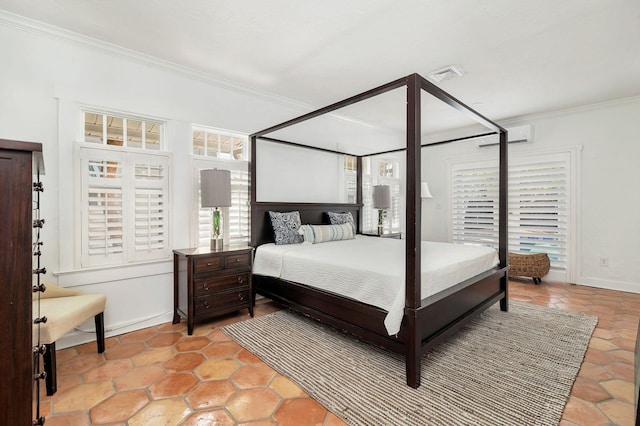 bedroom with baseboards, visible vents, and ornamental molding