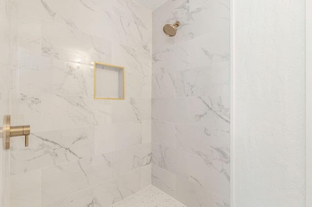 bathroom with tiled shower