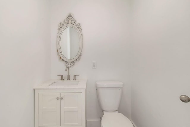 bathroom featuring toilet and vanity