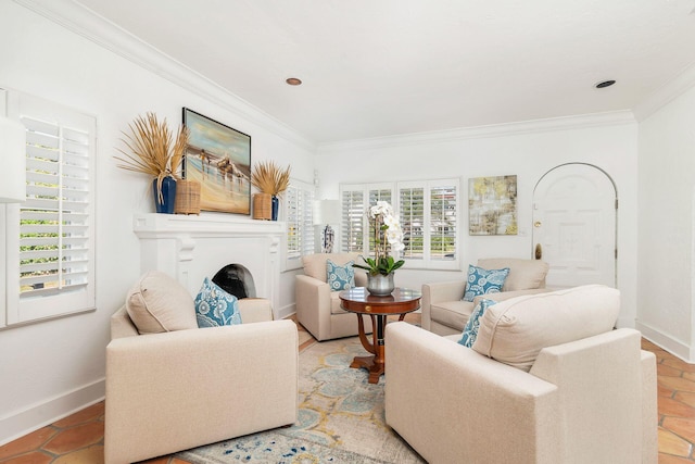 living room with baseboards, ornamental molding, and a fireplace