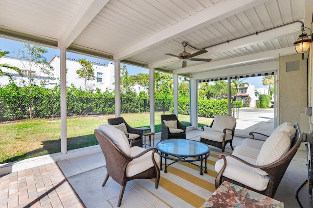 sunroom featuring beamed ceiling, visible vents, and ceiling fan