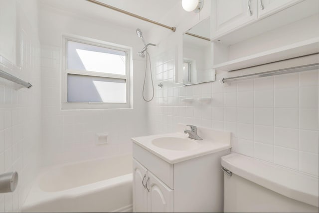 full bathroom with tub / shower combination, toilet, vanity, decorative backsplash, and tile walls