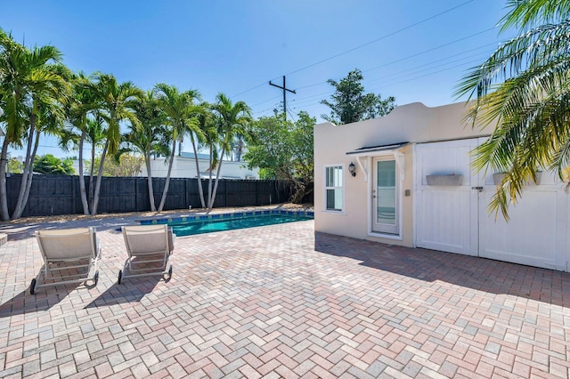 view of swimming pool featuring a patio area, a fenced backyard, and a fenced in pool