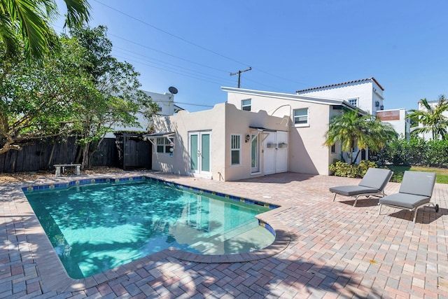 view of pool with a patio area, a fenced in pool, and fence