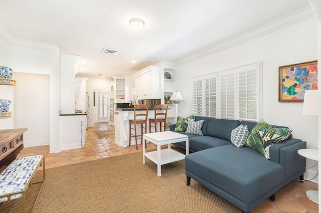 living area featuring light tile patterned flooring, visible vents, and crown molding