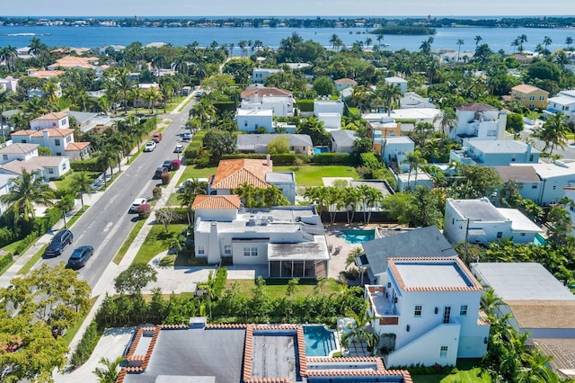 drone / aerial view featuring a residential view and a water view