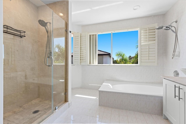 full bath featuring tile patterned flooring, a shower stall, vanity, and a garden tub