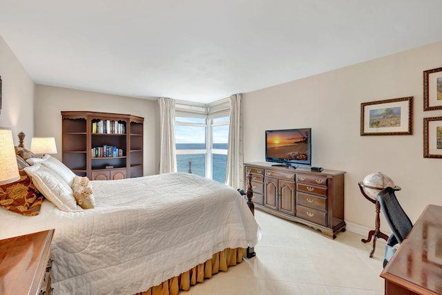 bedroom featuring light tile patterned floors and baseboards