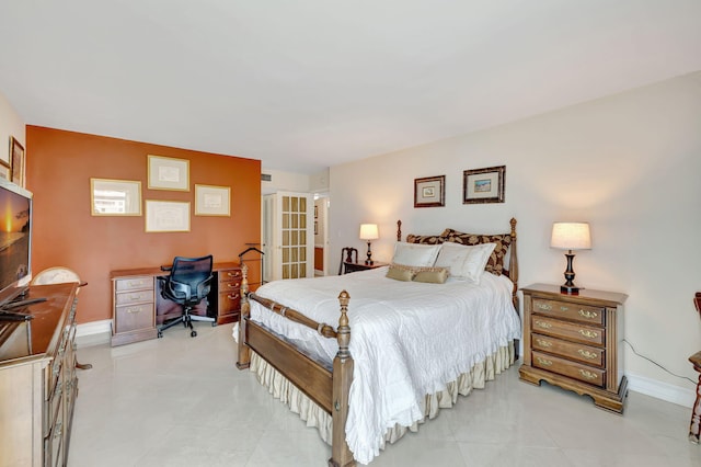 bedroom featuring light tile patterned floors, french doors, and baseboards