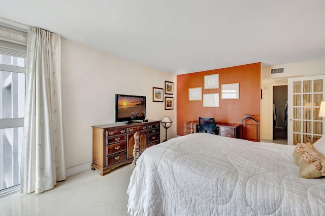 bedroom with visible vents and light tile patterned flooring