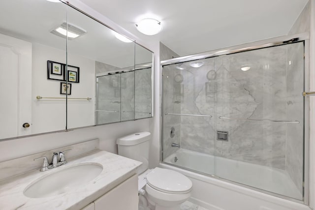 bathroom with vanity, toilet, visible vents, and shower / bath combination with glass door