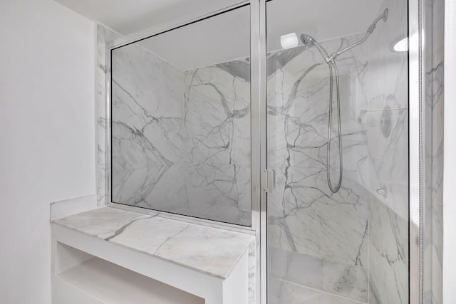 full bathroom with a marble finish shower