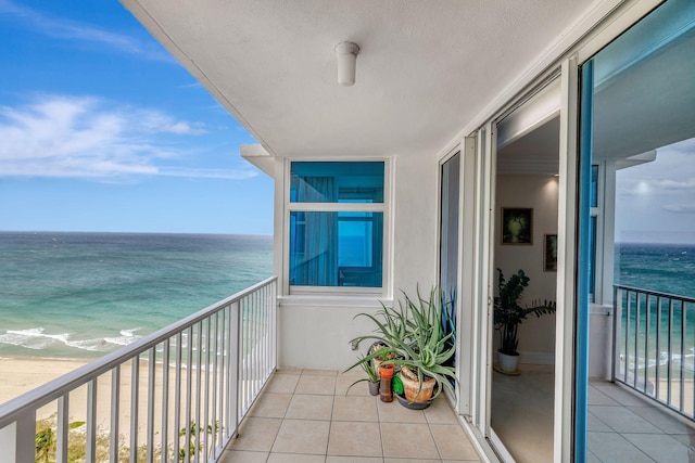 balcony with a beach view and a water view