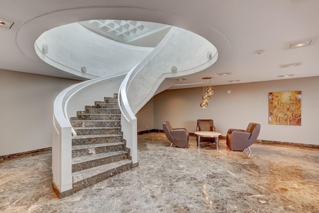 living area with stairway and baseboards