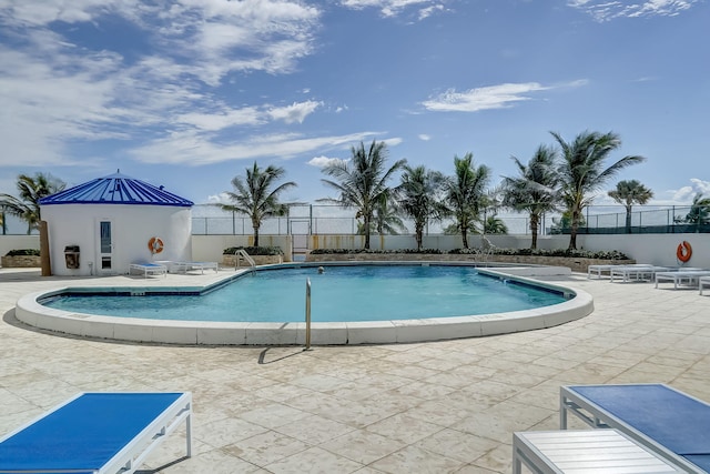 pool featuring a patio and fence